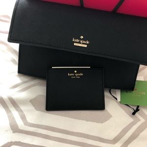 Kate Spade crossbody in hand.